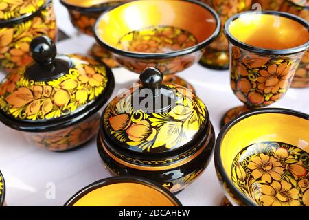 Painted wooden dishes on a market counter Stock Photo