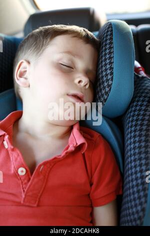 Portrait of boy sleeping in car seat Stock Photo