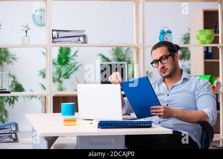 Young employee working in the office Stock Photo