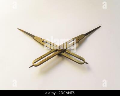 Brass reduction compass or proportional scale divider. Geometry tool used to scale up or down designs and in navigation to transfer distance on charts Stock Photo