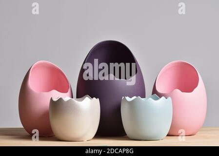Set of multicolored vases in the form of an eggshell on a gray background for easter Stock Photo