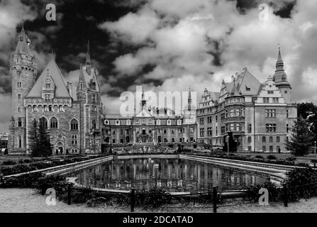 Moszna Castle with dramatic sky behind in black and white photography. Stock Photo