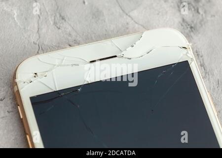Broken phone with a crack on the display glass. Stock Photo