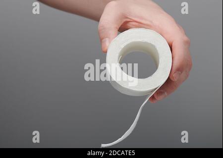 Last piece of toilet paper in hand side view isolated Stock Photo