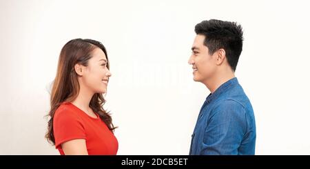 Portrait of happy couple isolated on white background. Attractive man and woman being playful. Stock Photo