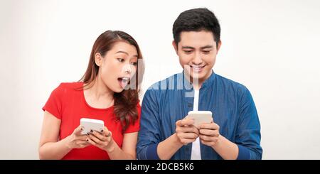 surprised Asian couple watching the smartphone Stock Photo