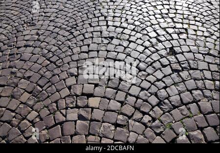 Antique granite cobblestone street pavement. Abstract geometrical background. Stock Photo