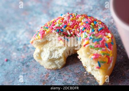 half eaten donuts and coffee mug on table  Stock Photo