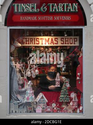 Lyndsey McDermott sorts a window display at her Christmas Shop, Tinsel & Tartan in Stirling. The shop will close today due to latest restrictions with her online business to continue. Eleven local council areas in Scotland will move into Level 4 restrictions from 6pm on Friday to slow the spread of coronavirus. Stock Photo