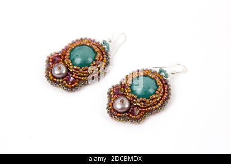 Ornament necklace beads earring amethyst turquoise luxury With tidewater green emerald natural stone, beaded jewellry on white background Stock Photo