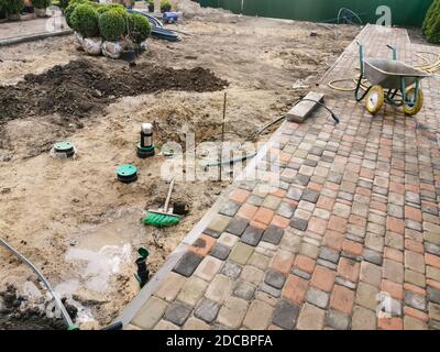 industrial worker installing pavement rocks, cobblestone blocks on road pavement Stock Photo