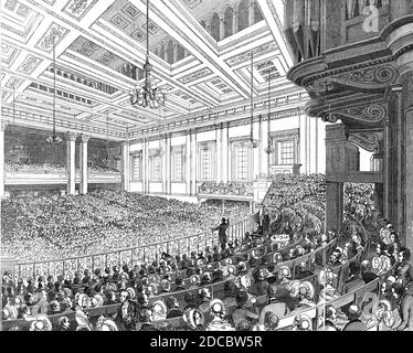 &quot;May Meetings&quot; in the Metropolis - interior of Exeter Hall, 1844. Exeter Hall in the Strand, London: '...herein are held several anniversaries during the month of May. Our engraving represents one of these impressive reunions...The Great Hall is 90 feet broad, 138 in length, and 48 high, and is lighted by 18 large windows. It will hold 3000 persons with comfort, and 4000 crowded. The platform, at the east end, shown in our engraving, will accommodate 500 persons, and is fenced from the rest of the hall by a railing, within which is seated the chairman, surrounded by persons influenti Stock Photo