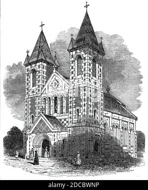 New church, at Kensall Green, 1844. The church of St John the Evangelist at Kensal Green in London: '...built in the Anglo-Norman style, of black brick, relieved with flint; the western front has two square towers, with high-pitched roofs, with a pinnacle at each angle, surmounted with a cross, as is also the main roof. Each tower has three stories, the upper most of which has belfry windows. These towers flank the centre also of three stories; the lowest is occupied by a gabled porch, with a deeply-recessed doorway, the columns of which are of stone, but most of the mouldings of the arches ar Stock Photo