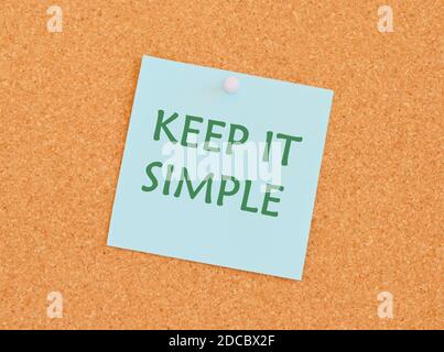 KEEP IT SIMPLE reminder note over a kork board.Text sign showing Keep It Simple. Conceptual photo ask something easy understand not go into too much d