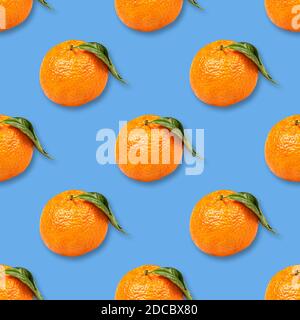 Christmas seamless background from ripe tangerines isolated on blue Stock Photo