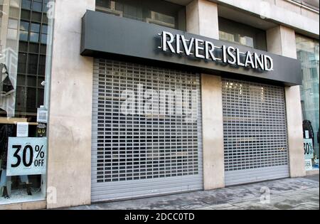 London, UK. 19th Nov, 2020. View of a closed and shuttered River Island store on Oxford Street.Midway thru the month long Second nationwide Covid-19 Lockdown which is due to end on December 2nd and some usually busy streets of London are empty. Credit: SOPA Images Limited/Alamy Live News Stock Photo