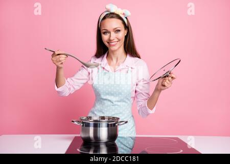 Portrait of her she nice attractive pretty lovely cheerful cheery brown-haired housewife cooking homemade tasty yummy fresh dinner tasting soup Stock Photo