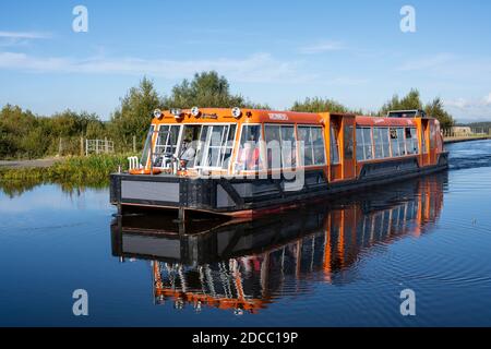 Canal boat on elevated section of canal at top of the Falkirk Wheel rotating boat lift in Falkirk, Scotland, UK Stock Photo