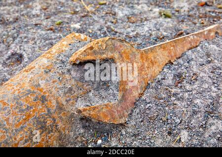 Industrial large metal spanner lying on the ground Stock Photo