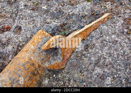 Industrial large metal spanner lying on the ground Stock Photo
