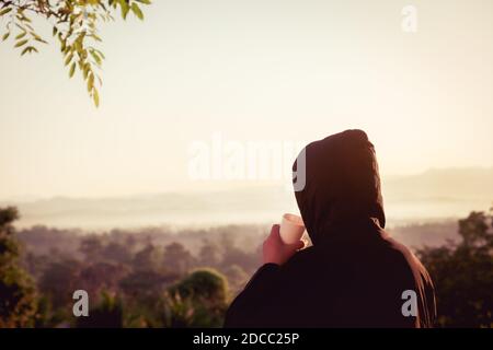 Traveler man wearing sweater and drinking a mug of hot coffee Stock Photo