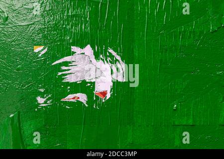 Green scratched distressed textured urban background with torn street posters Stock Photo