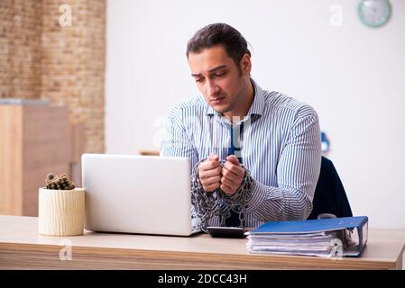 Chained employee working in the office Stock Photo