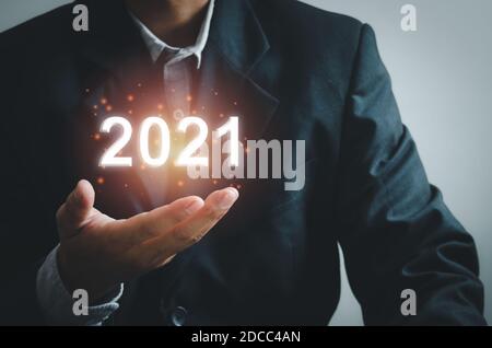 businessman hand touching on 2021 virtual screen. business concept new year. Stock Photo