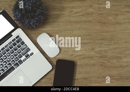 Modern office desk table with Office supplies computer laptop , smart phone , tree and mouse on top view and copy space.Flat lay Business concept desk Stock Photo