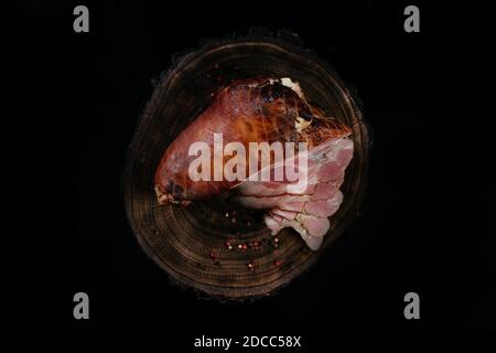 Smoked pork leg thigh, traditional meat. Top view. Dark background Stock Photo