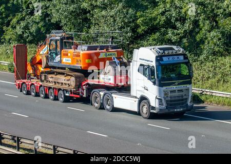 TDR Heavy haulage; STGO CAT 2 oversize wide loads, abnormal transport, DX350LC-7 Stage V Excavator construction equipment contractors, oversize load, specialist transporters, Nooteboom special-purpose vehicle trailers on the M61 Motorway UK Stock Photo