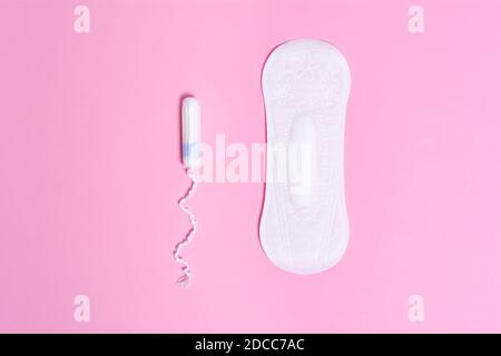 Feminine hygiene products. Tampon and daily panty liner on a pink background. Choice concept Stock Photo