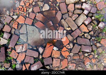 Very bad road conditions, a road surface consisting of rubble and mud Stock Photo