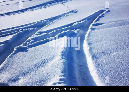 Traces of car tires on the snow Stock Photo