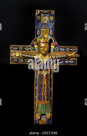 A copper champleve crucifix plaque, partially gilded and enamelled, executed circa 1200-1215 in Limoges, France, depicting Christ the King triumphant on the cross, on display at the Cluny Museum in Paris, France Stock Photo