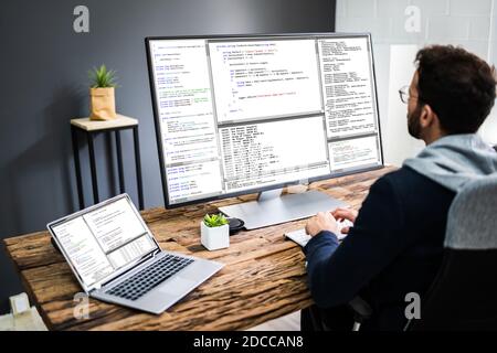 Software Developer Programmer Using Computer In Work From Office Stock Photo