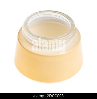 open empty yellow shiny glass jar for cosmetic cream isolated on white background Stock Photo