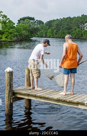 Louisiana St. Tammany Parish Northshore,Slidell,Liberty Bayou,crabbing fishing man teen teenager boy friends pier, Stock Photo