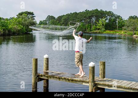 Louisiana St. Tammany Parish Northshore,Slidell,Liberty Bayou,crabbing fishing teen teenager boy pier tossing net, Stock Photo