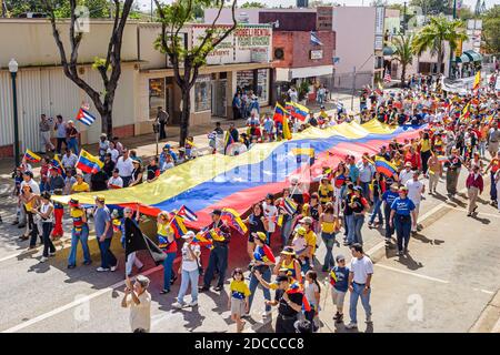 Miami Florida,Little Havana,Hispanic man men,Calle Ocho political protest Fidel Castro Hugo Chavez,signs banners marching Venezuelans Cubans, Stock Photo