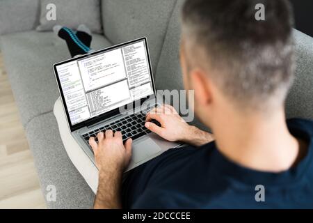 Software Developer Programmer Working On Laptop Computer Stock Photo