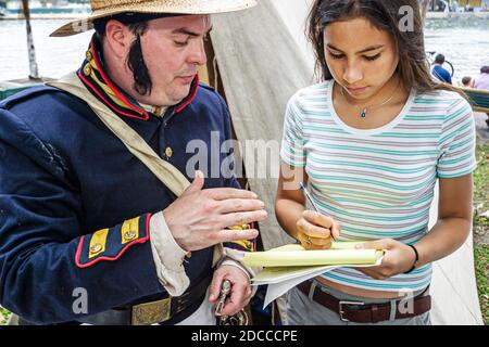 Miami Florida,Riverday Miami River event festival,Jose Marti Park fair student interviews reenactor man pioneer,original settler costume girl female, Stock Photo