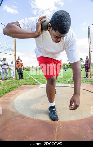 Miami Florida,Tropical Park Greater Miami Athletic Conference championships,track & field high school student students concentration,shot put competit Stock Photo