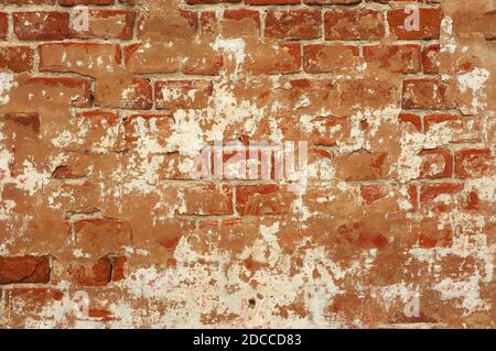 Wall of old concrete and red weathered bricks. Old brick wall. Plaster background grunge texture Stock Photo