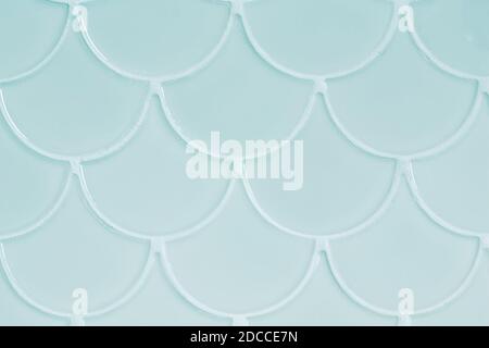 Light blue ceramic tiles in the form of scales. Mosaic Tiles on the wall Stock Photo