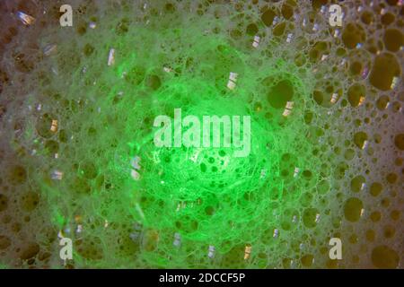 A Macro image of Green Milky bubbles and Coloured Window Reflections Stock Photo