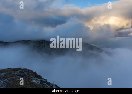 Atmospheric landscape with huge clouds over the mountain. Dramatic skies enveloped the mountains. Sad autumn landscape before the rain. Crimean nature Stock Photo