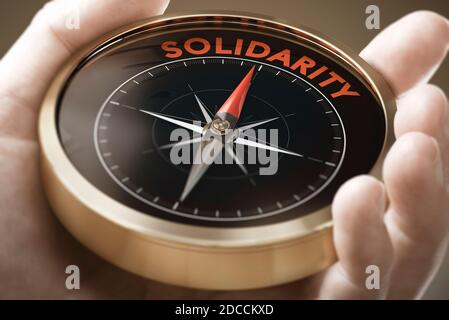 Man hand holding compass with needle pointing the word solidarity. Sociology concept. Composite image between a hand photography and a 3D background.