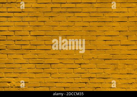 Brick wall with yellow or mustard, color masonry. Wall with small Bricks. Modern wallpaper design for web or graphic art projects. Abstract template o Stock Photo