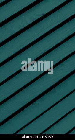 Wooden textured background with diagonal planks. Vintage turquoise or blue wood background texture with knots. Vertical banner toned in trendy 2021 co Stock Photo